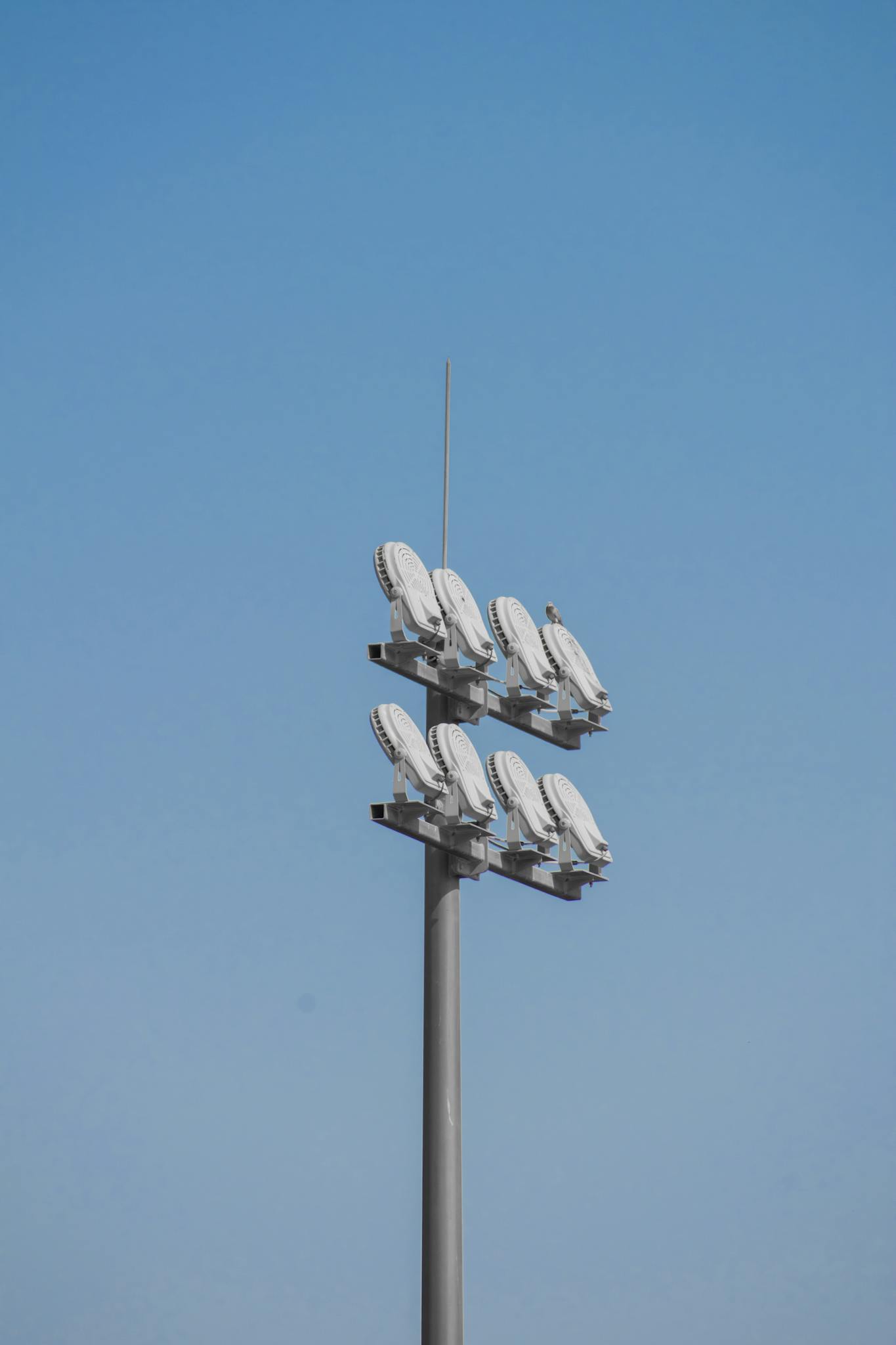 Tower with antennas against a clear blue sky. Perfect for technology themes.